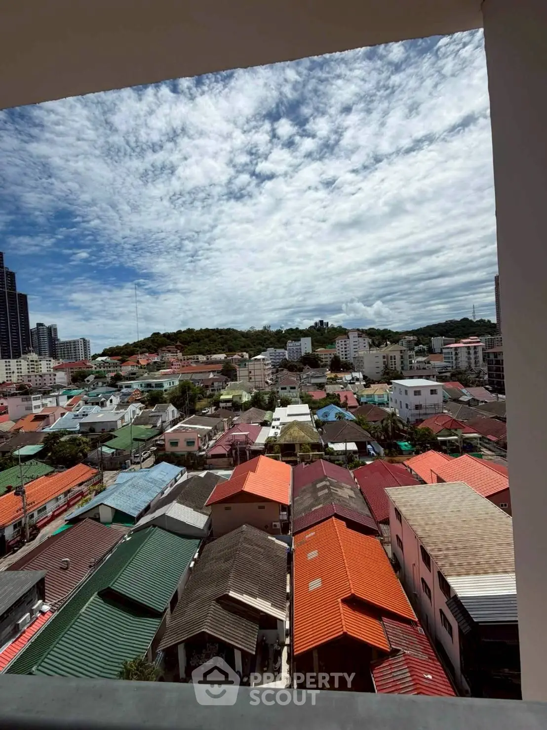 Stunning panoramic view of colorful rooftops and cityscape from a high vantage point, perfect for urban living.