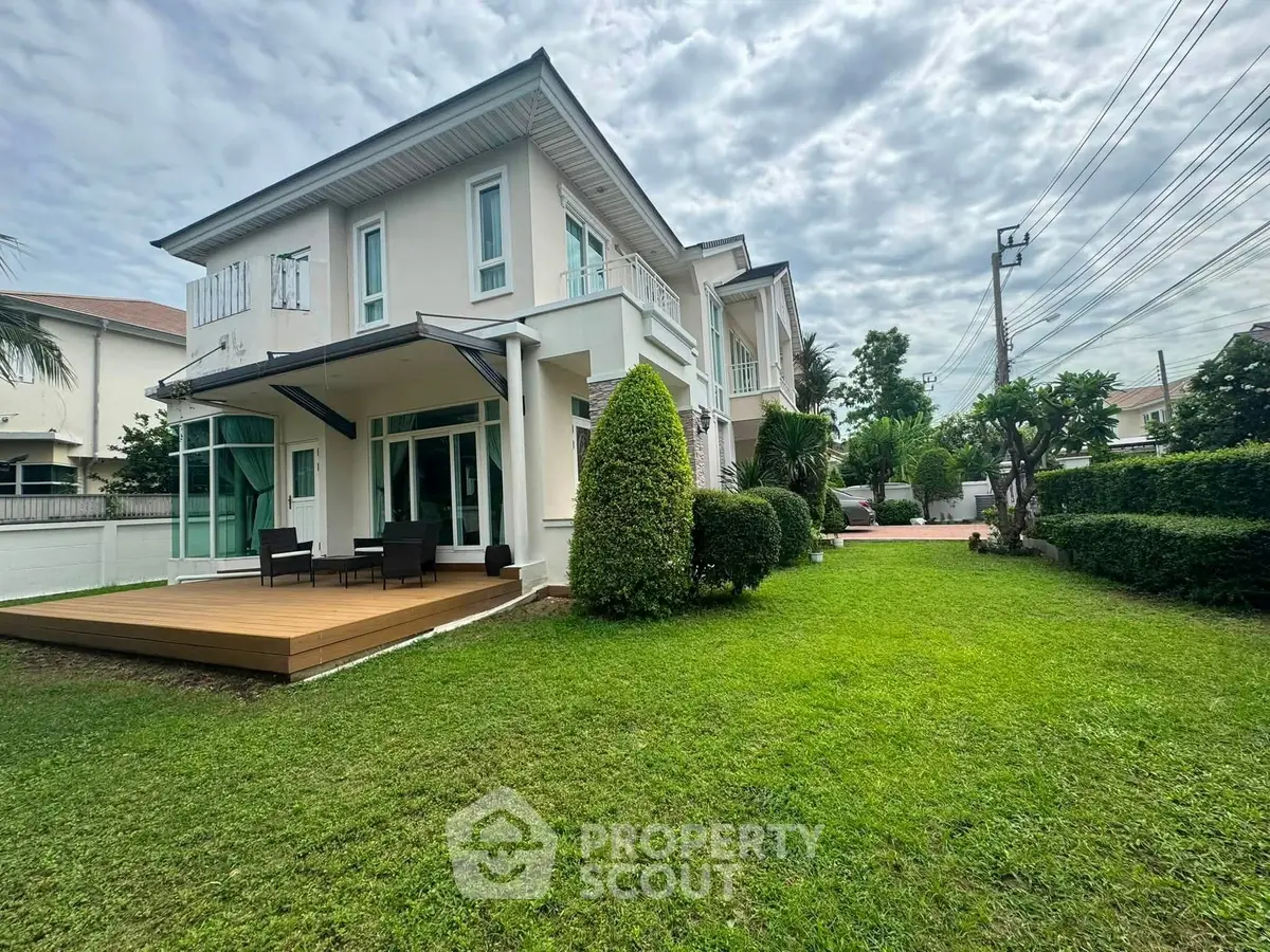 Elegant two-story house with spacious garden and modern patio in a serene neighborhood.