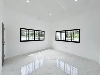 Spacious bright room with large windows and glossy marble flooring