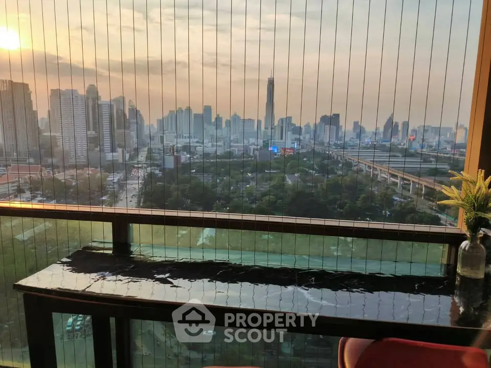 Stunning cityscape view from a high-rise balcony at sunset, perfect for urban living.
