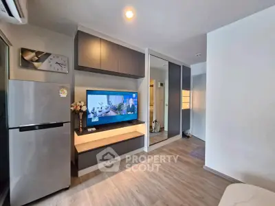 Modern living room with sleek cabinetry and mounted TV, featuring a stylish open layout and contemporary design.