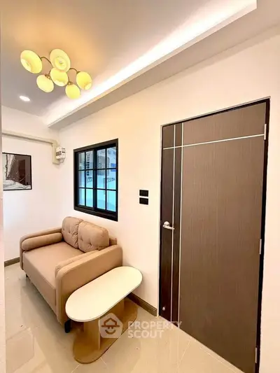 Modern living room with stylish sofa and elegant lighting in a cozy apartment.