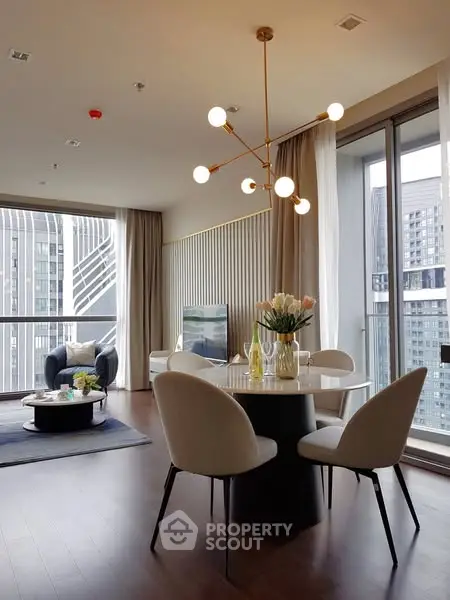 Modern dining area with elegant lighting and city view in luxury apartment.