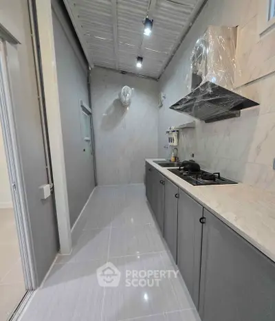 Modern kitchen with sleek cabinetry and gas stove in a stylish apartment.