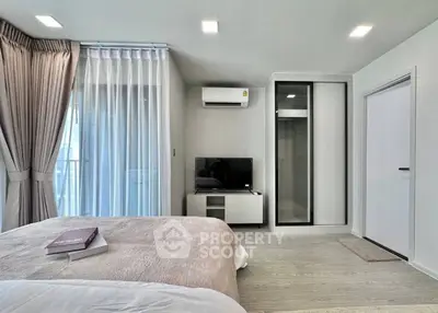 Modern bedroom with balcony, featuring sleek design and natural light, perfect for urban living.