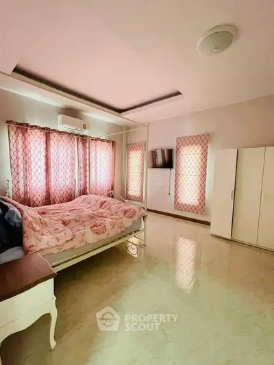 Spacious bedroom with elegant decor and natural light, featuring a cozy bed and modern wardrobe.