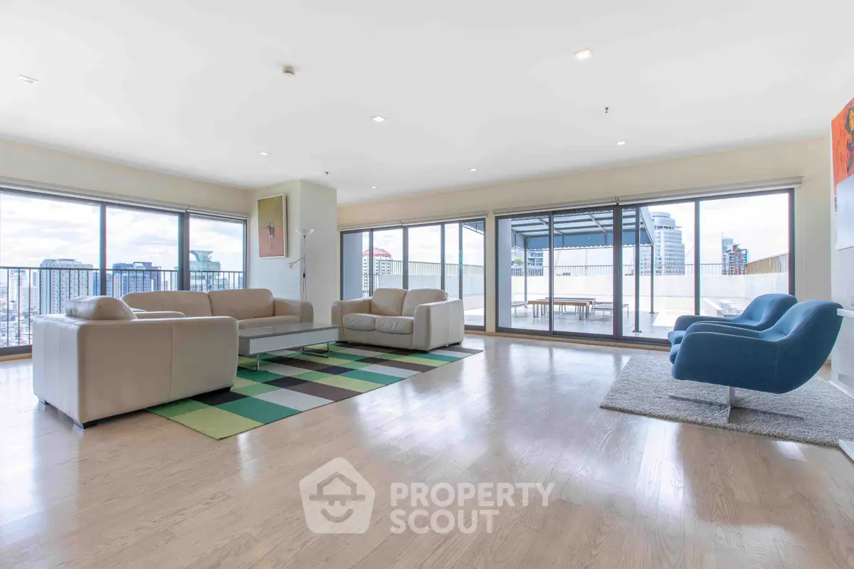 Spacious modern living room with panoramic city views and stylish furniture
