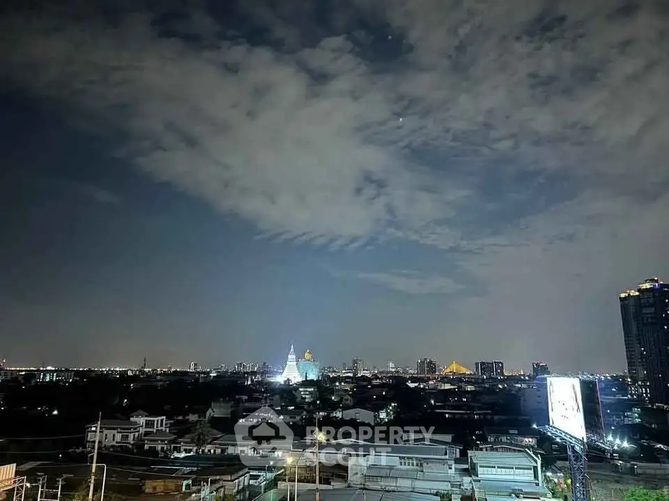 Stunning cityscape view with illuminated skyline and dramatic night sky.