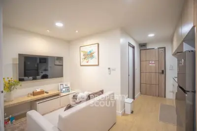 Modern living room with cozy sofa and wall-mounted TV in stylish apartment.