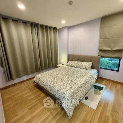 Cozy bedroom with wooden flooring and elegant curtains in modern apartment