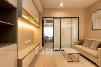 Modern living room with sleek furniture and warm lighting, featuring a cozy sofa and stylish decor.