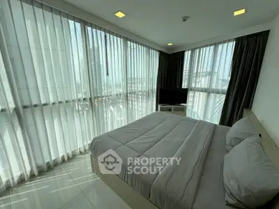 Spacious bedroom with panoramic windows and modern decor