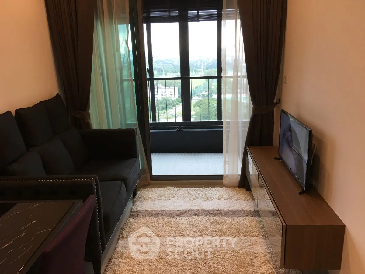 Modern living room with balcony view and stylish furniture