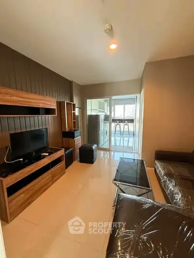 Modern living room with sleek furniture and balcony view in urban apartment