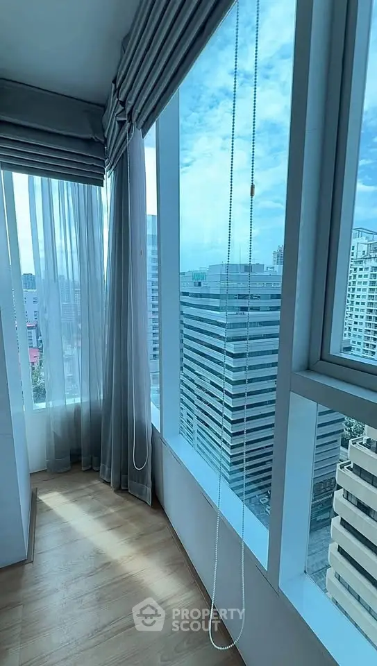 Stunning high-rise apartment corner with panoramic city views and floor-to-ceiling windows.