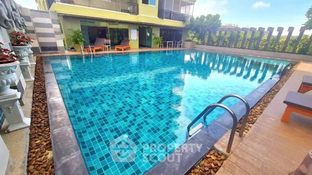 Luxurious outdoor pool area with modern design and relaxing lounge chairs, perfect for leisure and entertainment.