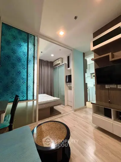 Modern studio apartment with stylish decor and open layout, featuring a cozy living area and compact bedroom.