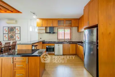 Spacious modern kitchen with wooden cabinets and stainless steel appliances