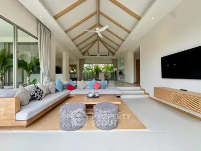 Luxurious open-plan living room with vaulted ceiling and modern decor