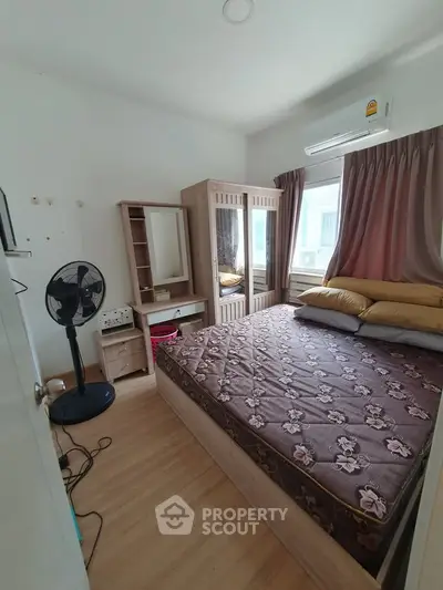 Cozy bedroom with air conditioning and stylish wooden furniture