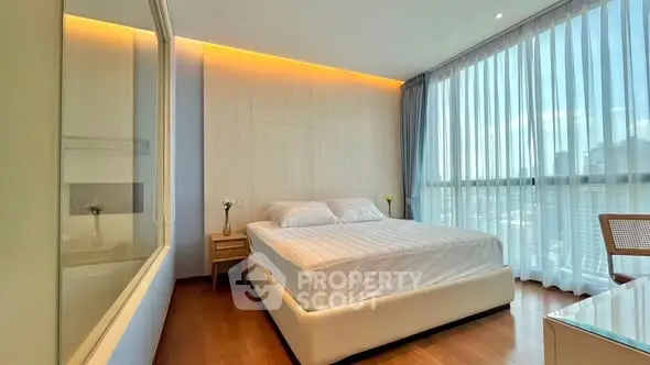 Spacious modern bedroom with large windows and elegant decor