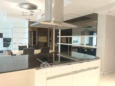 Modern kitchen with sleek black countertops and open layout in luxury apartment