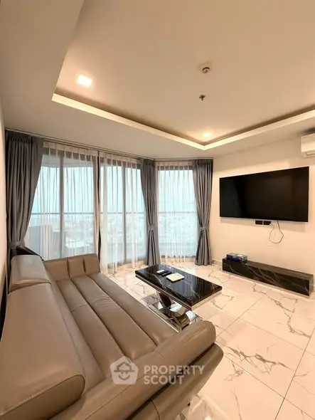 Luxurious modern living room with panoramic city views and sleek leather sofa.