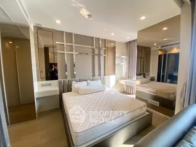 Modern bedroom with stylish decor and large mirror in a luxury apartment