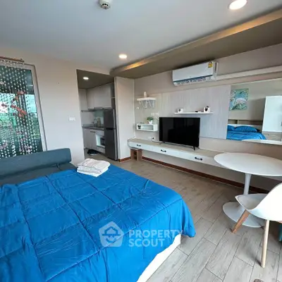 Modern studio apartment with cozy living area and compact kitchen