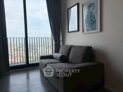 Modern living room with a cozy sofa and stunning city view from the balcony.