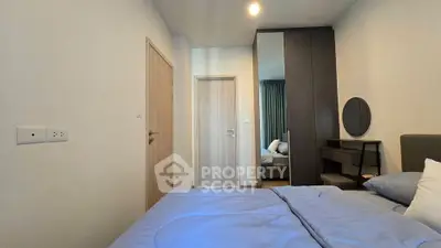 Modern bedroom with stylish decor and cozy bedding in a contemporary apartment.