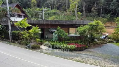 Charming rustic house with lush garden and scenic road view