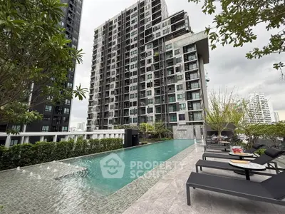 Luxurious high-rise apartment with stunning pool and modern amenities in urban setting.