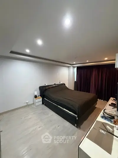 Spacious modern bedroom with sleek design and ambient lighting