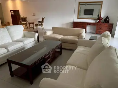 Spacious living room with elegant furniture and large mirror