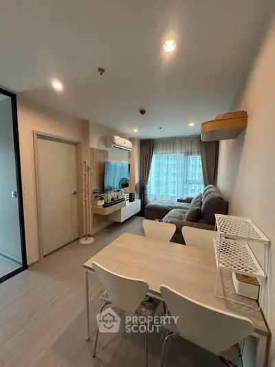 Modern living room with cozy sofa and dining area in a stylish apartment.