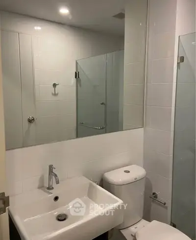 Modern bathroom with sleek fixtures and glass shower enclosure