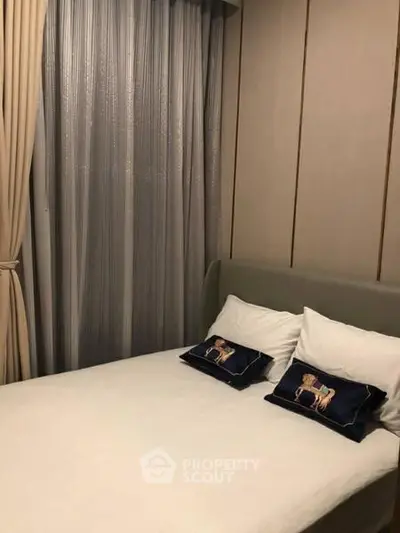 Cozy bedroom with elegant decor and plush pillows in a modern apartment.