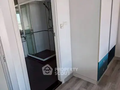 Modern apartment with sleek bathroom and stylish flooring, perfect for urban living.