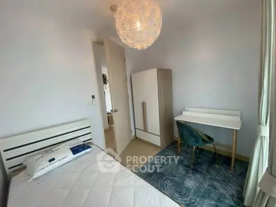 Cozy bedroom with modern decor, featuring a stylish desk and wardrobe.