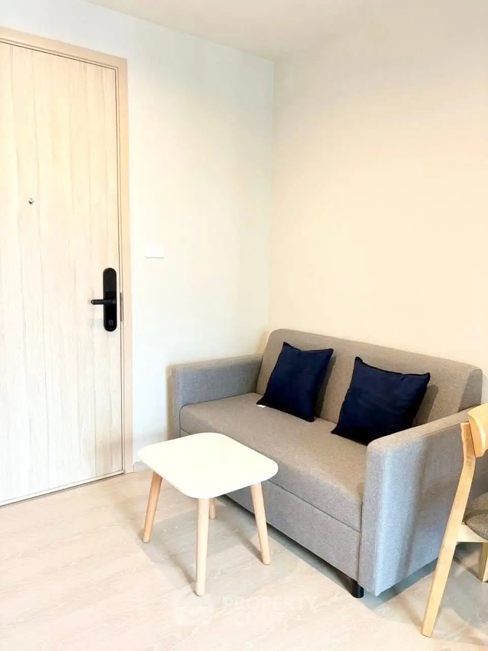 Cozy living room with modern sofa and wooden accents in a stylish apartment.