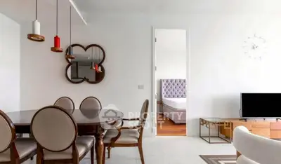 Modern dining area with elegant furniture and view into a stylish bedroom