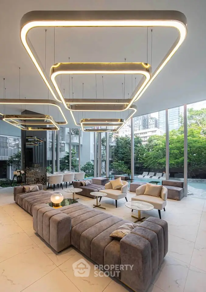 Luxurious modern living room with unique lighting and floor-to-ceiling windows overlooking a lush garden.