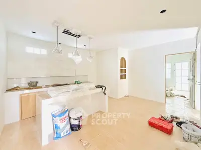 Spacious kitchen under renovation with modern lighting and open layout