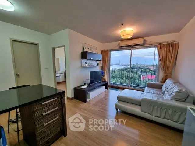 Spacious living room with modern decor and stunning view through large window.