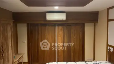 Cozy bedroom with wooden accents and air conditioning unit