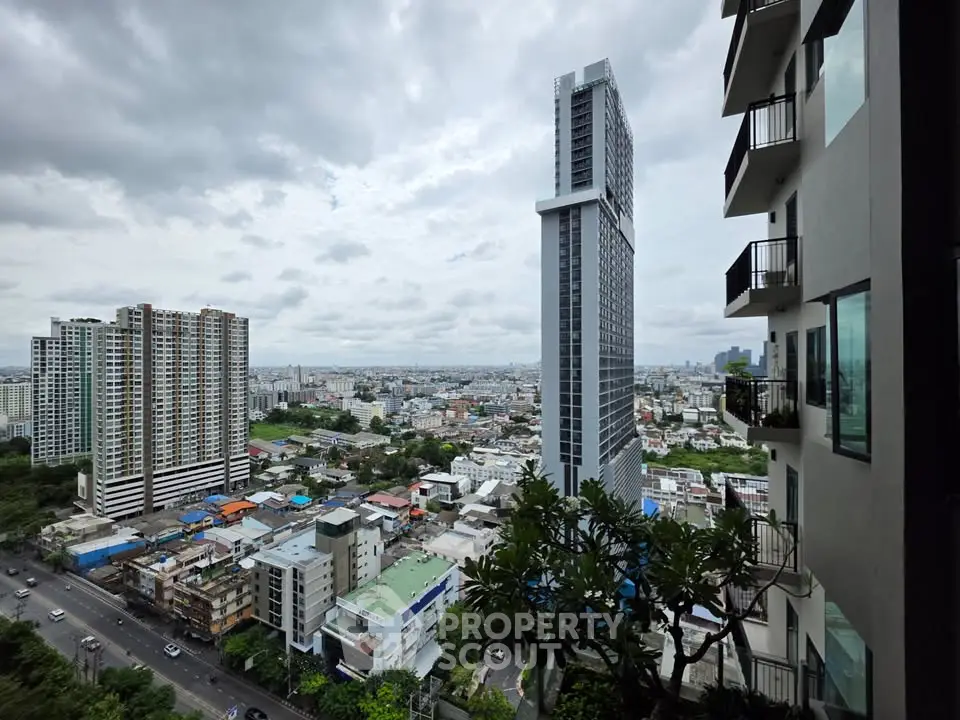 Stunning cityscape view from high-rise building balcony with modern architecture.