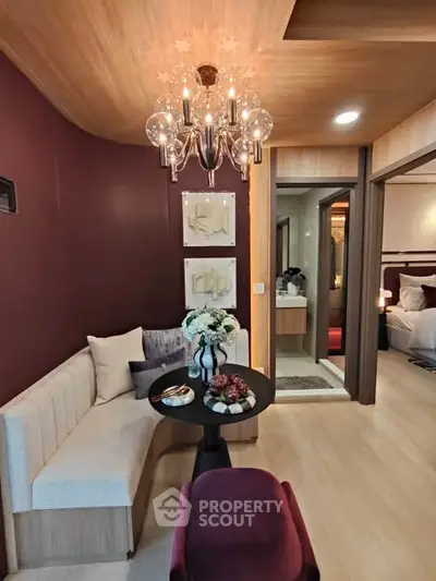 Stylish modern living room with elegant chandelier and cozy seating area