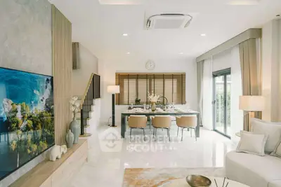 Luxurious open-plan living and dining area with modern decor and ample natural light.