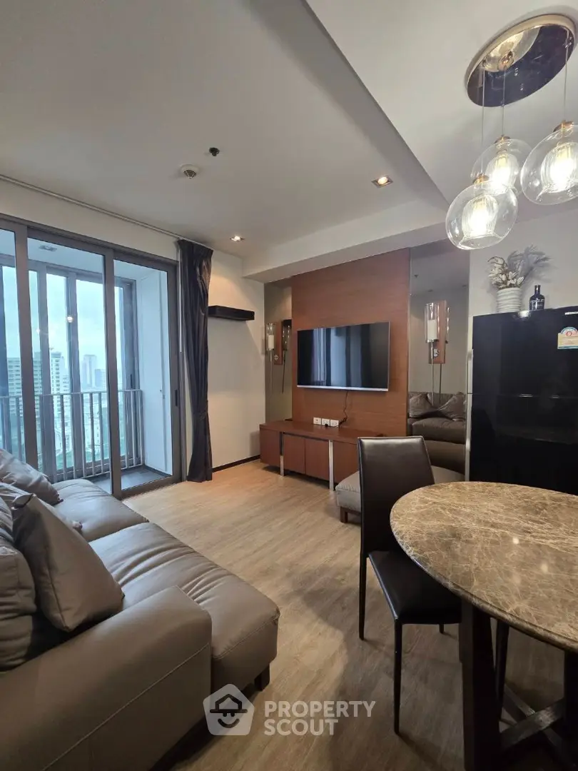 Modern living room with city view, featuring elegant decor and stylish furniture.